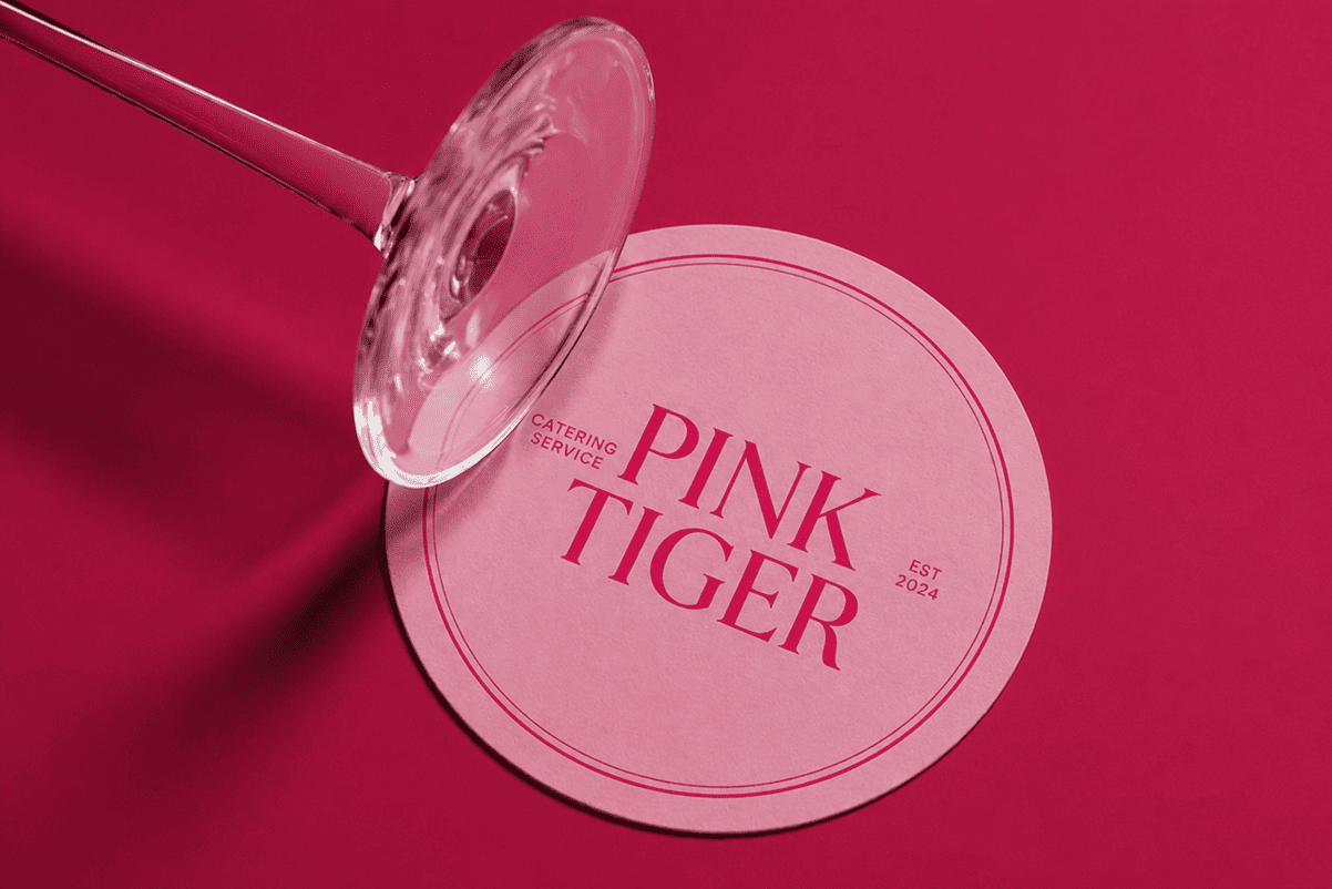 Pink Tiger coaster with wine glass stem on pink background