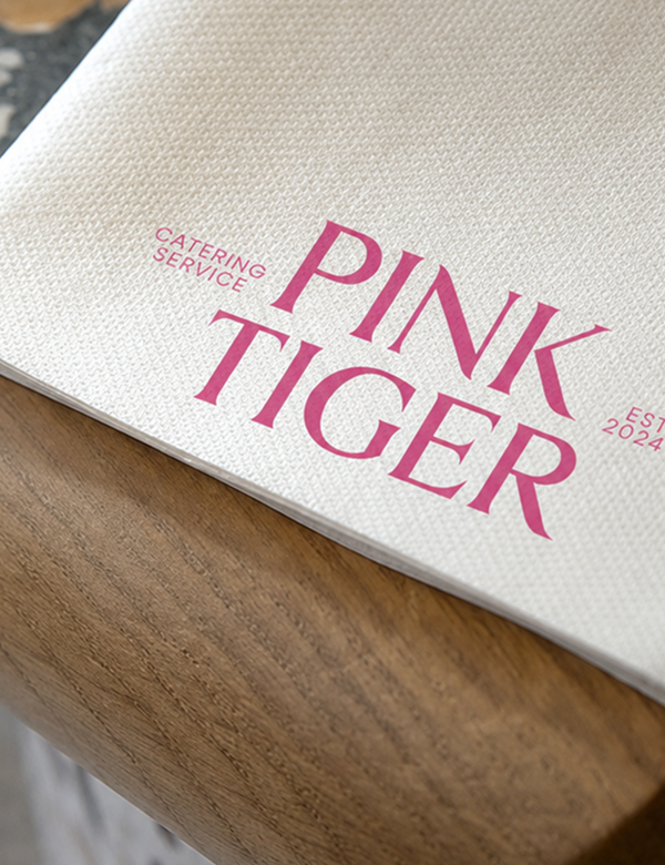 Pink Tiger embroidered logo close-up on white linen