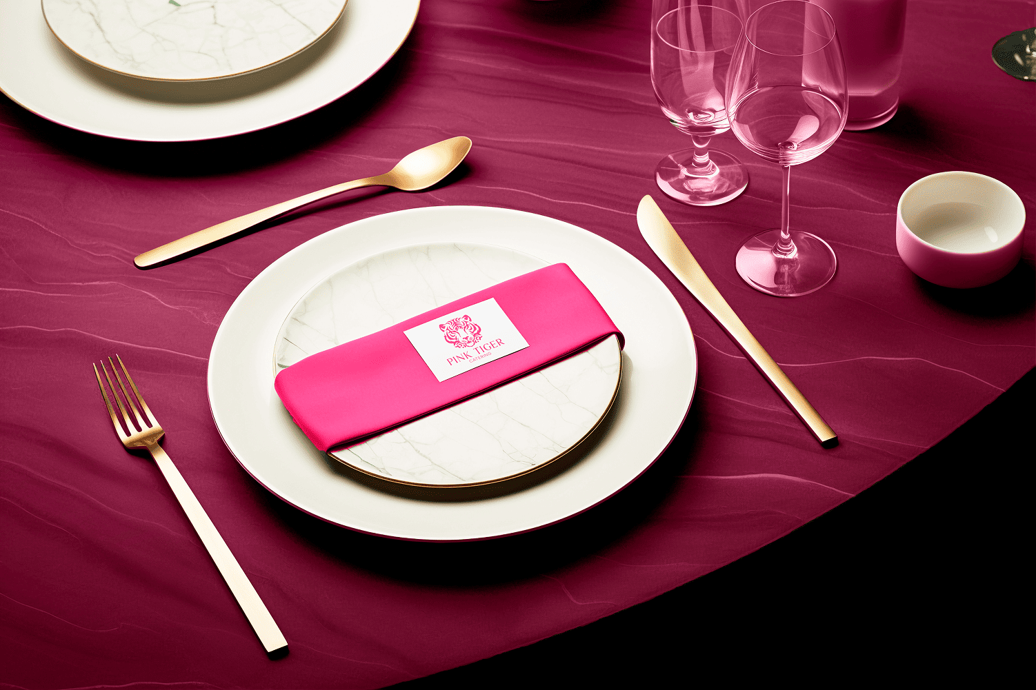 Pink Tiger place setting with pink napkin and gold cutlery